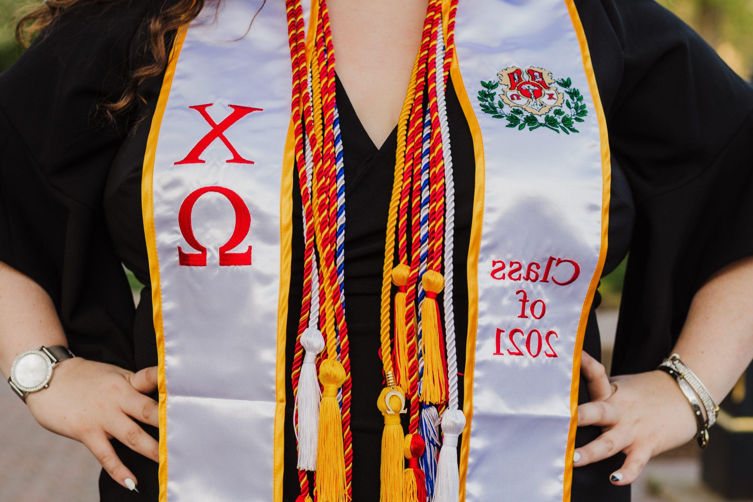 Graduation cords 和 stole hanging from a womans neck